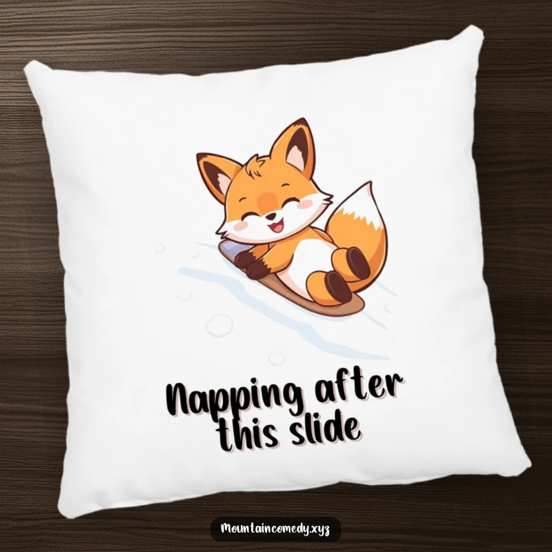 Funny pillow with a happy fox character doing a belly slide on a snowy mountain, adding a touch of cozy humor to any room.