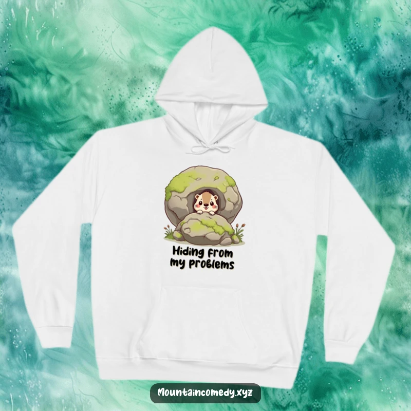 Funny marmot character curiously peering from behind a moss-covered boulder, humorous hoodie for cozy outdoor vibes, perfect gift.